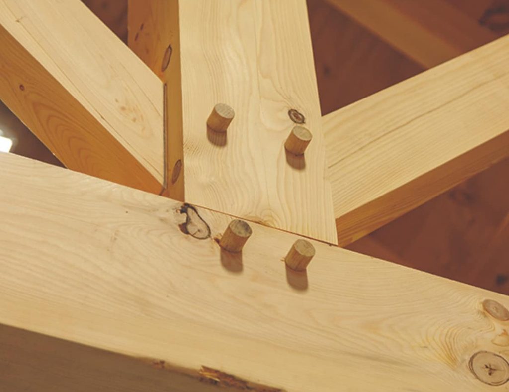 Close-up of mortise and tenon joint in interior of a custom horse barn.